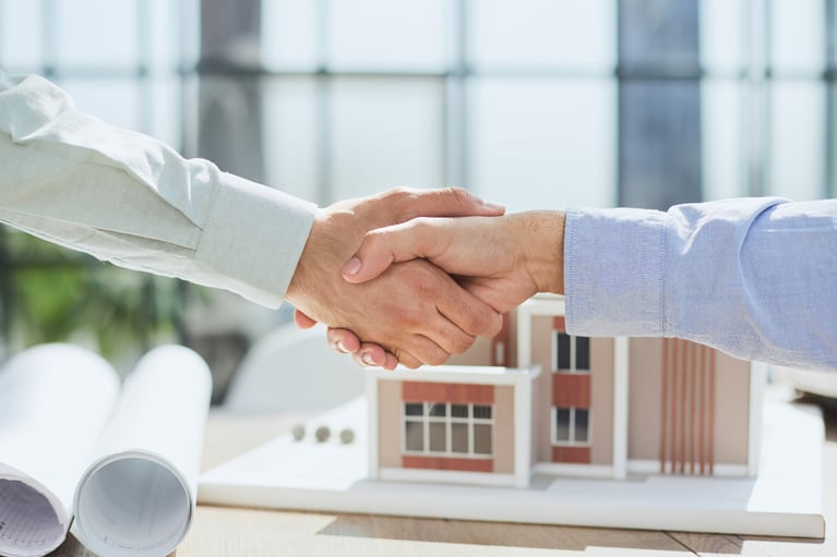 handshake-against-background-model-house-construction
